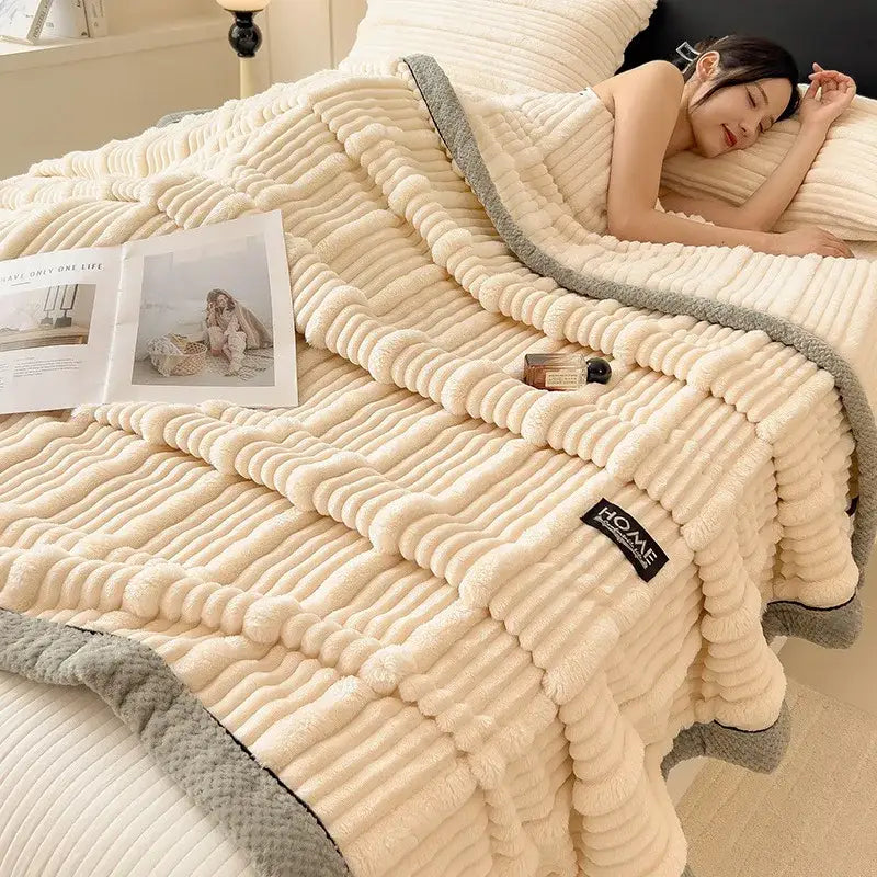 Cream-colored plush blanket with ribbed texture and gray fleece trim by home featuring cozy faux rabbit plush material