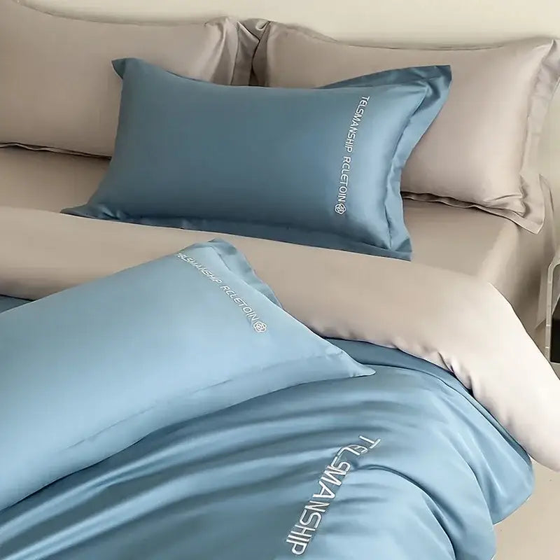 Light blue satin cotton embroidery pillowcase with subtle white text along edge from decorbites bedding set