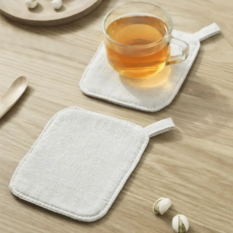 Light gray cotton linen coaster with small fabric loop handle from decorbites coaster set for dining room use