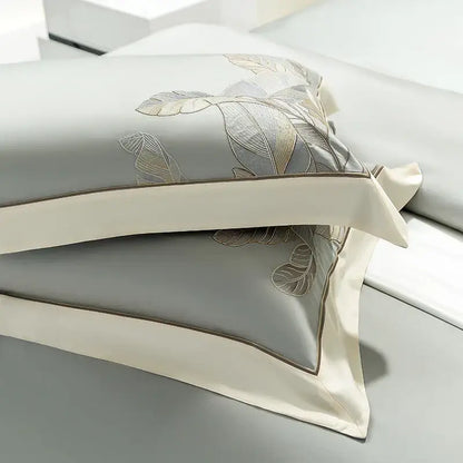 Light gray eucalyptus lyocell soft bedding set with gray satin pillowcases featuring gold and silver leaf embroidery edges
