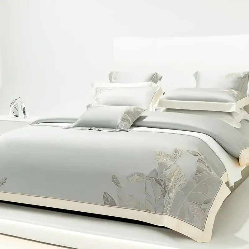 Light gray eucalyptus lyocell soft bedding set with delicate leaf embroidery and cream-colored border for bedroom decor