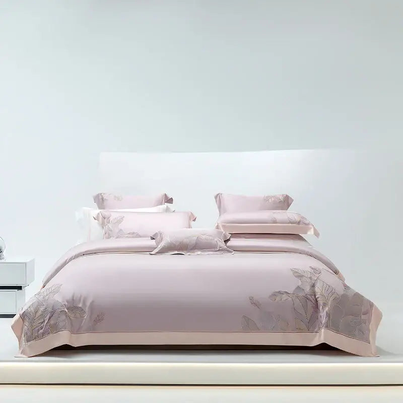 A soft blush pink satin bedding set with elegant leaf embroidery featuring decorbites eucalyptus lyocell soft fabric