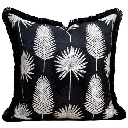 Black throw pillow cover with white embroidered palm fronds and black fringe trim for light luxury designer decor