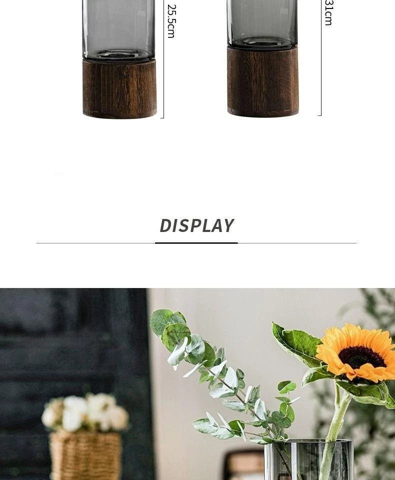 A sleek dark gray glass light luxury vase with wooden base holds sunflower and eucalyptus for living room decor