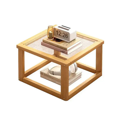 Light wood two tier coffee table set with glass top and open shelving for living room use