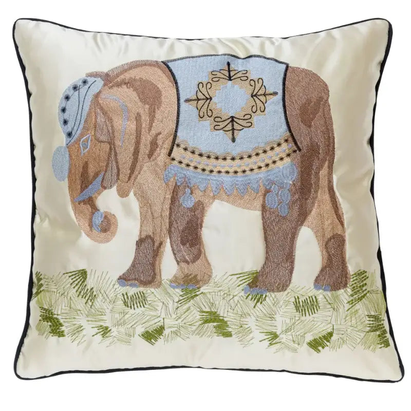 Cream-colored cushion cover with decorbites elephant embroidery in brown and blue on green grass for sofa decorbites elephant embroidery