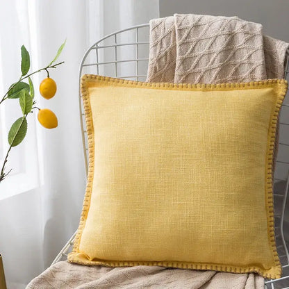 Square mustard-yellow linen fringe cushion cover with textured weave and stitched edges for neutral tones decorbites decor