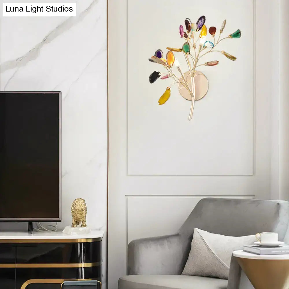 A modern lodge gold metallic branch wall lighting with colored crystal deco in gemstone-like glass leaves