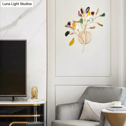A modern lodge gold metallic branch wall lighting with colored crystal deco in gemstone-like glass leaves