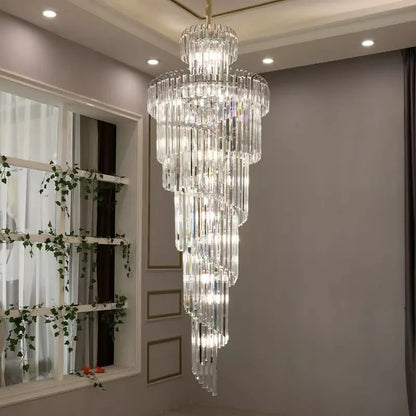 A multi-tiered long crystal staircase gold chandelier with clear glass rods and embedded lights for hotel hall decor