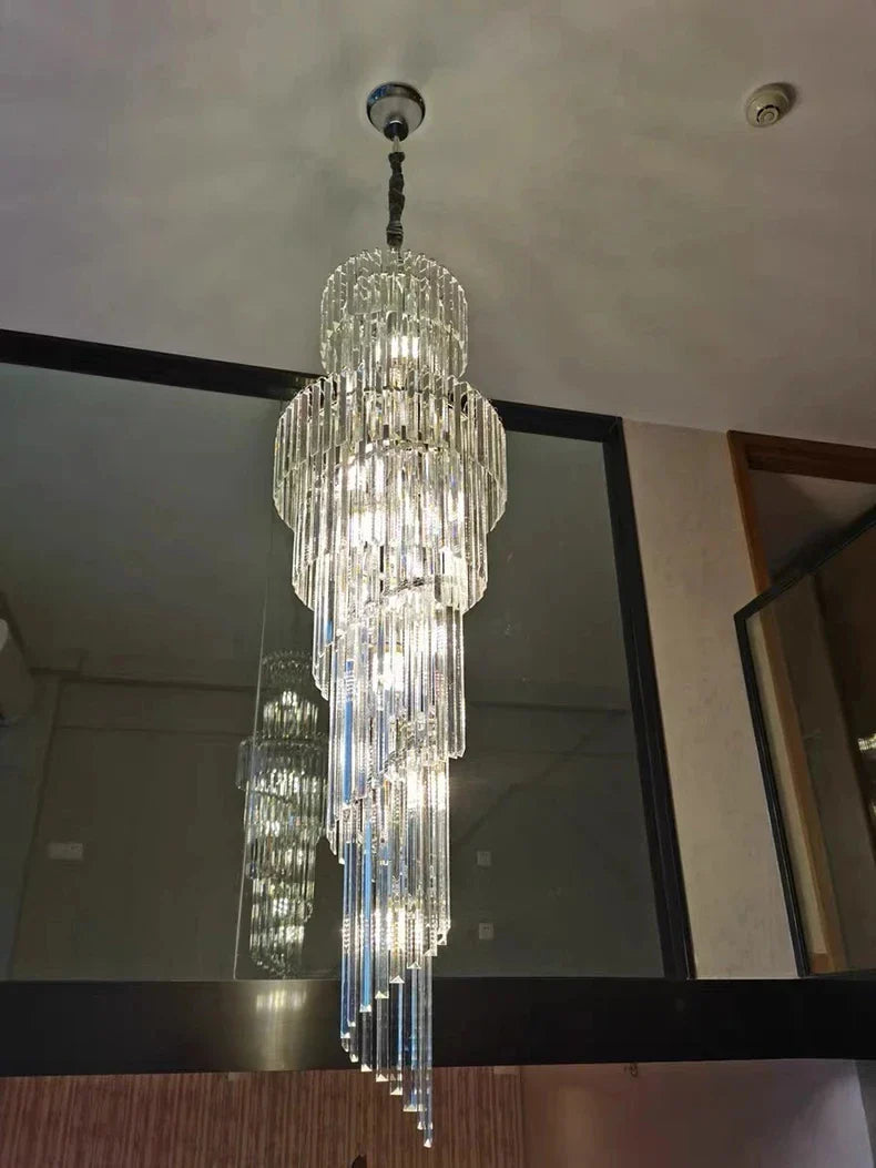 A long crystal staircase gold chandelier with cascading glass rods and metallic mount for hotel hall luxury decor