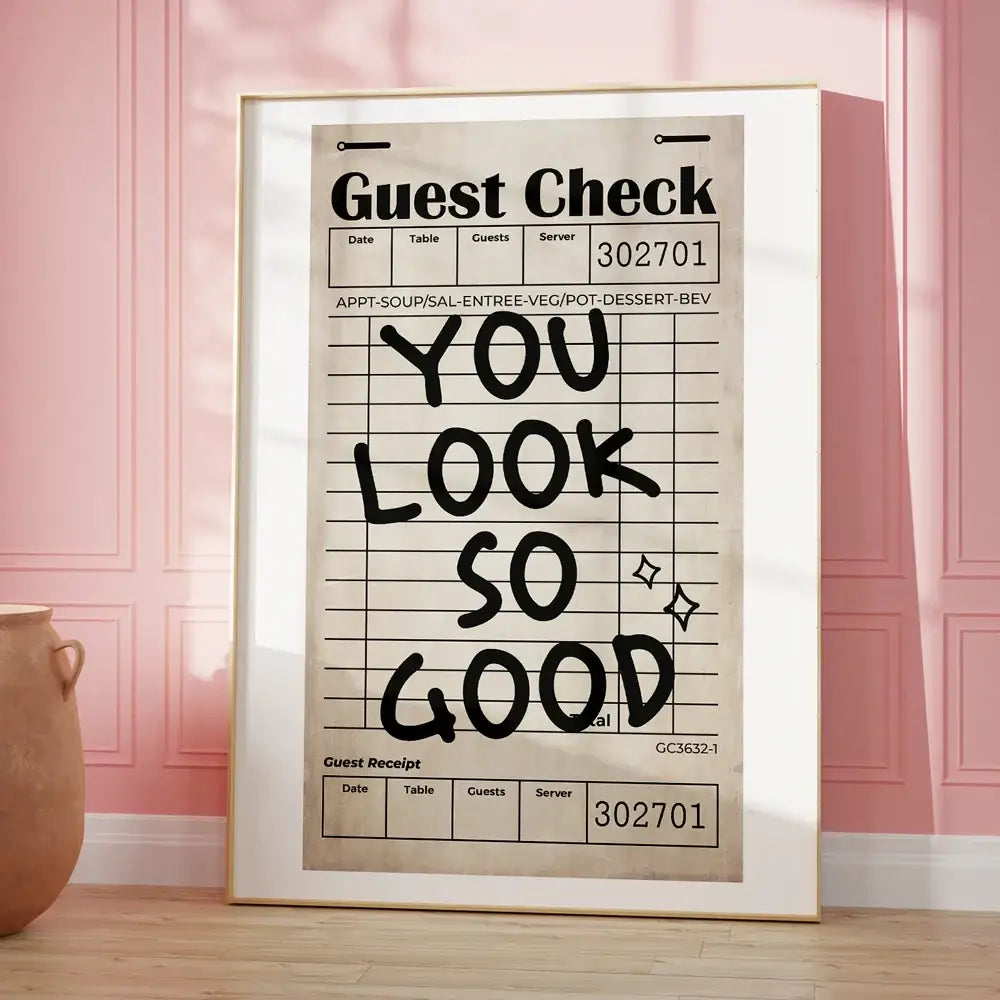 A framed decorbites™ vintage-style canvas wall art with bold black handwritten kind love quote on beige grid background