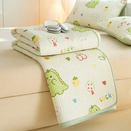 A cream-colored quilted cotton mattress mat featuring a lucky dinosaur decorbites cartoon pattern for bedroom bedding