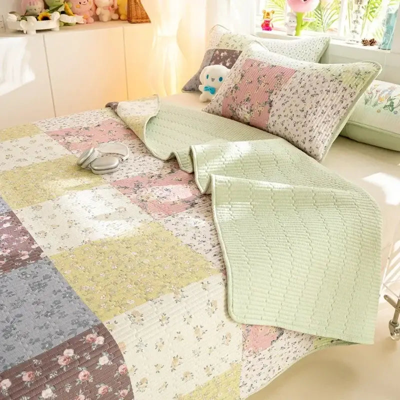 Pastel patchwork cartoon pattern cotton mattress mat with floral patterns in soft greens pinks and creams decorbites