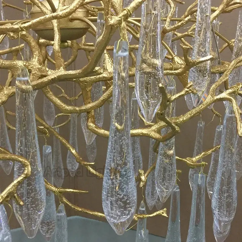 Luxe gold branch crystal led chandelier with clear bubble filled glass teardrop pendants for living room use