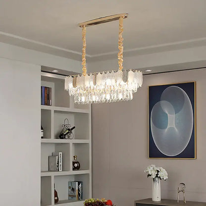 A luxe gold crystal indoor chandelier with a rectangular frame and cascading droplets by decorbites crystal indoor