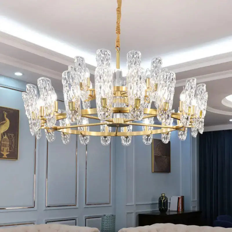 A luxe gold glass led ceiling chandelier with a gold-toned metal frame and clear crystal droplets for living room