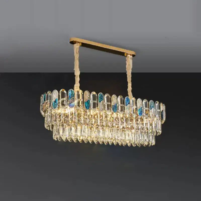 Elegant gold-toned decorbites dimmable led sea shell chandelier with cascading crystal droplets and blue glass panels for living room