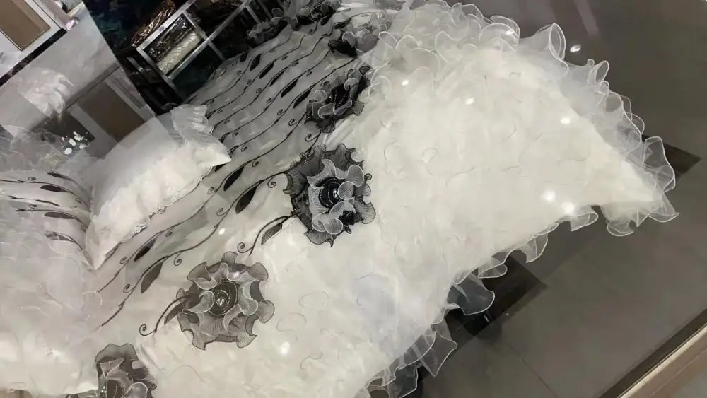 White bedspread with delicate ruffled edges and black embroidered floral patterns in decorbites jacquard rose lace bedding set