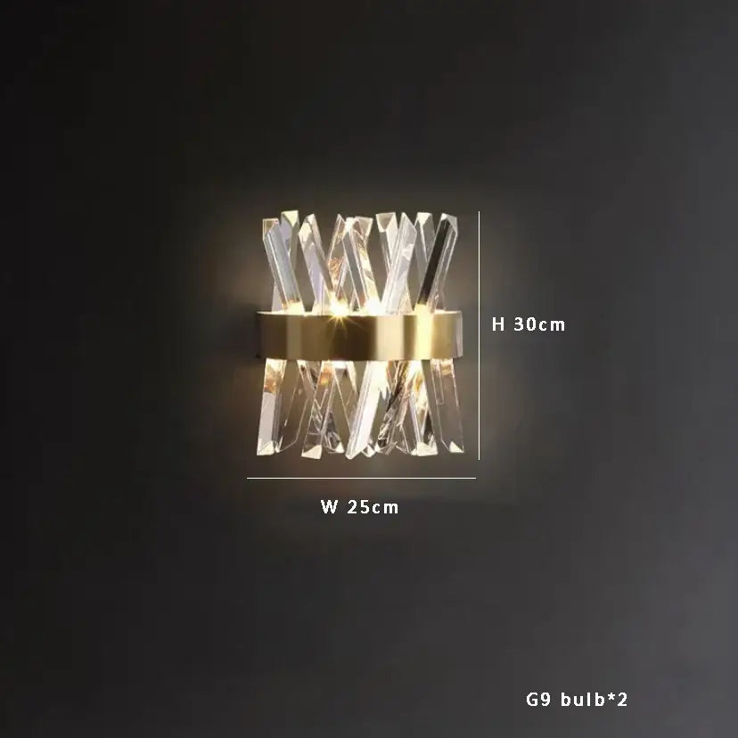 Modern crystal wall sconce with gold-toned metal base and clear glass complements decorbites black stainless steel chandelier