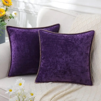 Two plush deep purple velvet throw pillows with dark brown stitched edges for luxury blue chenille cushion covers decorbites