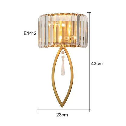 Gold-toned luxury brass crystal wall lamp with faceted shade and teardrop pendant for elegant bedroom decorbites crystal wall lighting