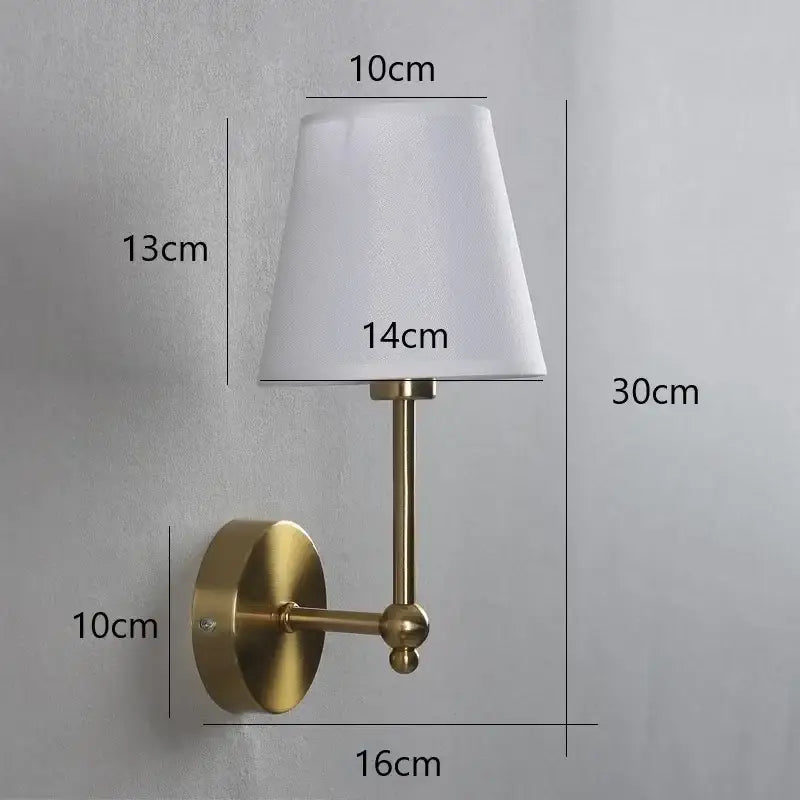 Brass-finished gold wall lamp with a white tapered fabric shade for luxury bedroom decorbites led black sconce