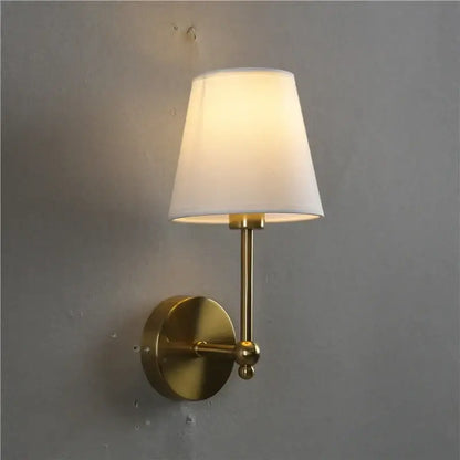 Luxury brass and gold wall lamp bedroom sconce with brass finish and tapered white fabric shade from decorbites led black collection