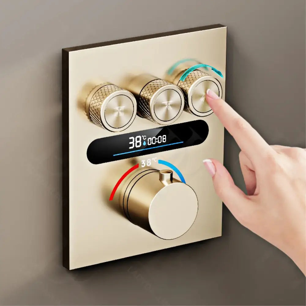 Luxury brushed gold digital rainfall shower system control panel with gold finish digital display and three textured knobs