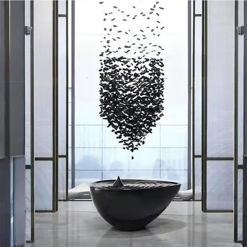 Black glossy ceramic bowl with central spout and ridges complementing decorbites crystal led chandelier lighting fixture