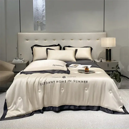 Luxury cream and black ice silk embroidered quilt set featuring a cream satin duvet cover with black trim and elegant home text