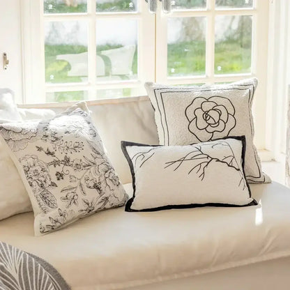 Luxury cream and black decorbites camellia jacquard pillow cover with embroidered floral design and contrasting piping