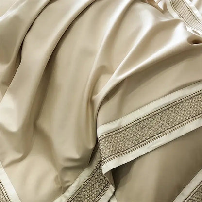 Cream-colored satin bedding set with subtle sheen and decorative woven border trim from decorbites 1000tc luxury embroidery