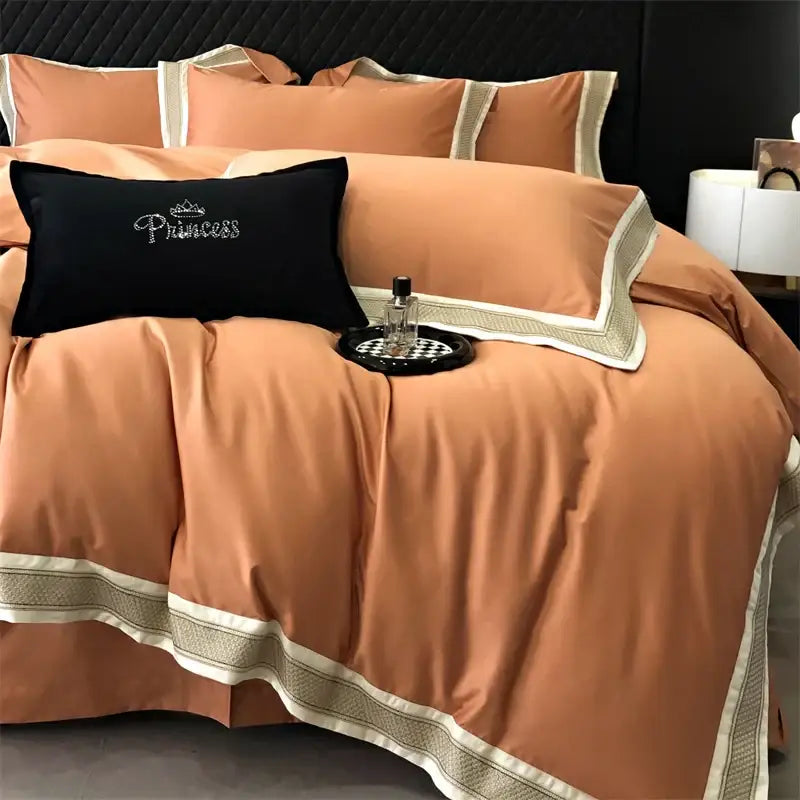 Coral-colored satin bedding set with cream and beige embroidered trim from decorbites 1000tc luxury embroidery collection