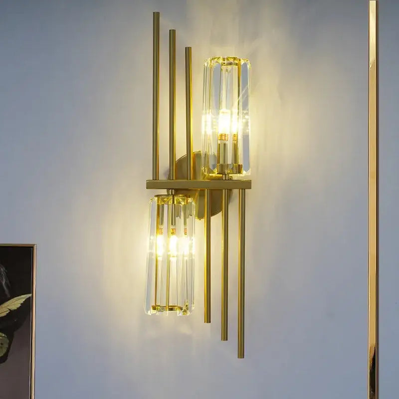 Luxury crystal gold wall lamp featuring gold-toned brass rods and clear crystal cylinders for living room and bedroom decorbites