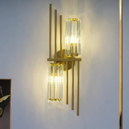 Luxury crystal gold wall lamp featuring gold-toned brass rods and clear crystal cylinders for living room and bedroom decorbites