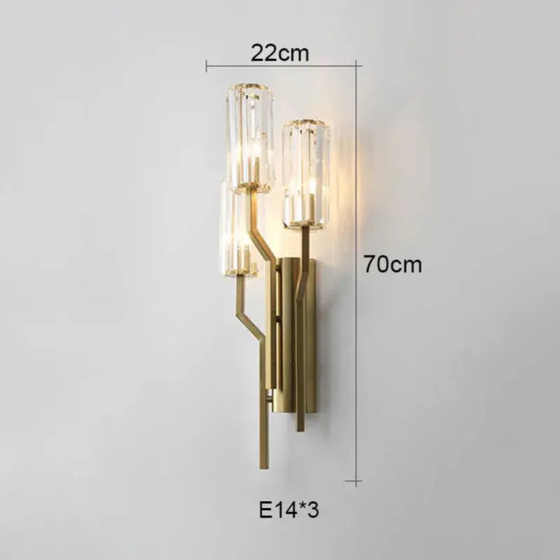 Luxury crystal gold wall lamp with gold-toned metal frame and three clear glass cylinders for living room lighting decorbites crystal gold