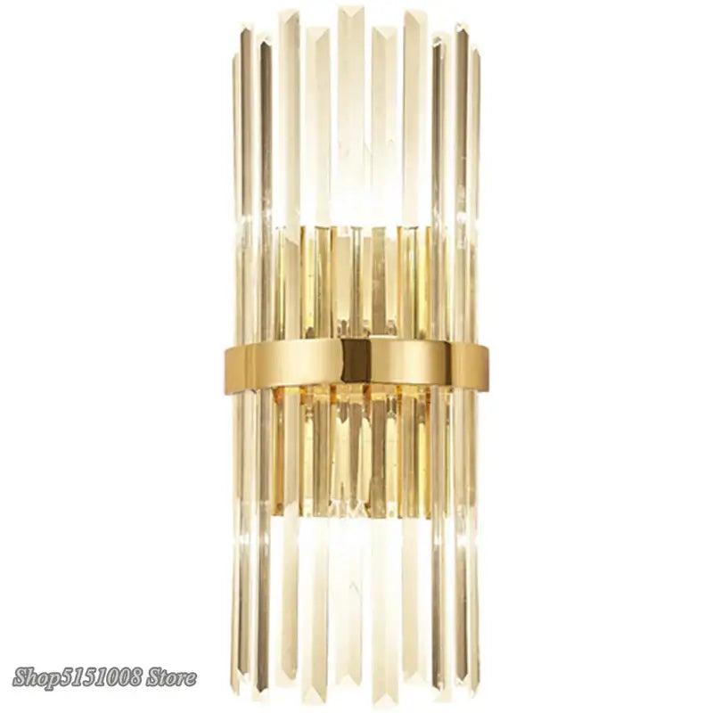 Luxury crystal golden wall lamp featuring gold-toned vertical crystal rods and a central metallic band by decorbites