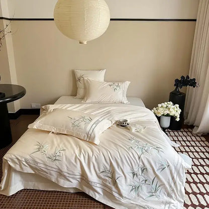 Cream-colored satin bedding set with gray bamboo embroidery and black piping in 1000tc egyptian cotton luxury design