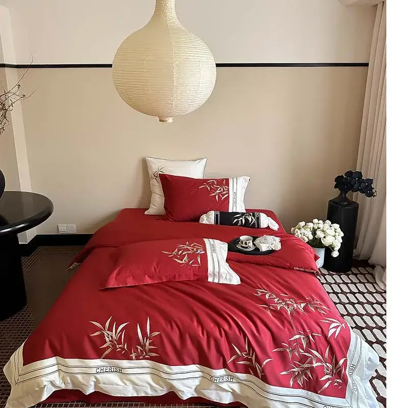 Red satin duvet cover set with embroidered bamboo motifs and white trim in a 1000tc egyptian cotton bedding set