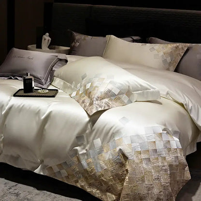 Cream satin duvet cover with gold and silver geometric embroidery along edge in luxury embroidery bedding set pearl white gray