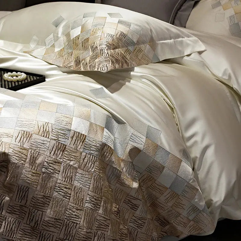Cream-colored satin luxury embroidery bedding set with geometric gold and silver woven threads in pearl white and grey