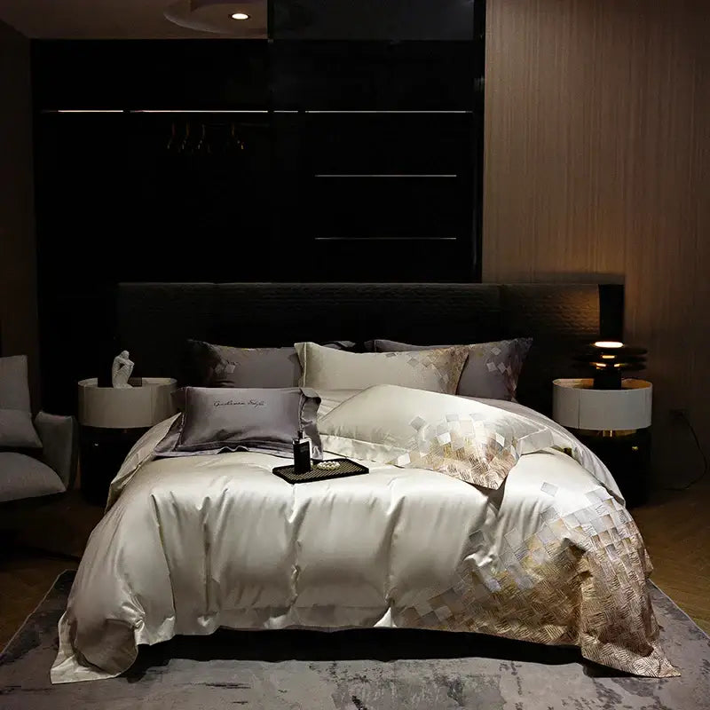 Cream-colored satin luxury embroidery bedding set with gold geometric embroidery and matching pillowcases in modern bedroom