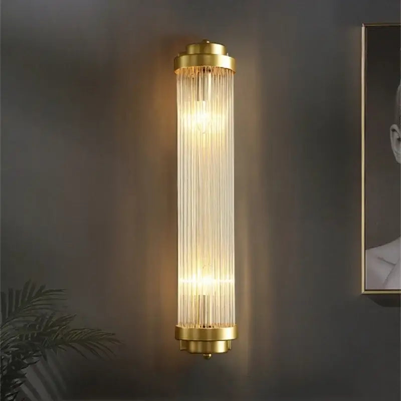 Luxury gold crystal led wall sconce with vertical glass prisms for bedroom featuring elegant gold finish and crystal design