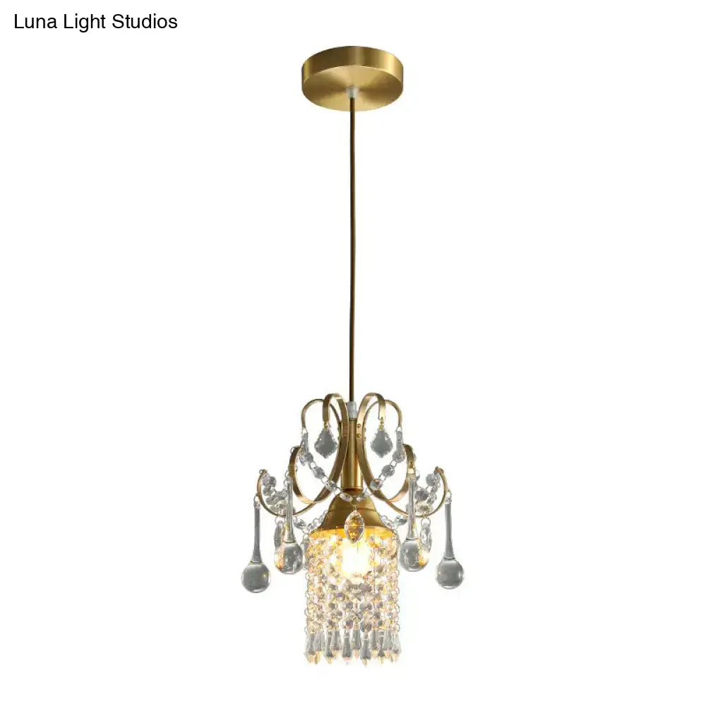 Gold-toned luxury single head pendant light with clear crystal droplets and warm central light for dining room use
