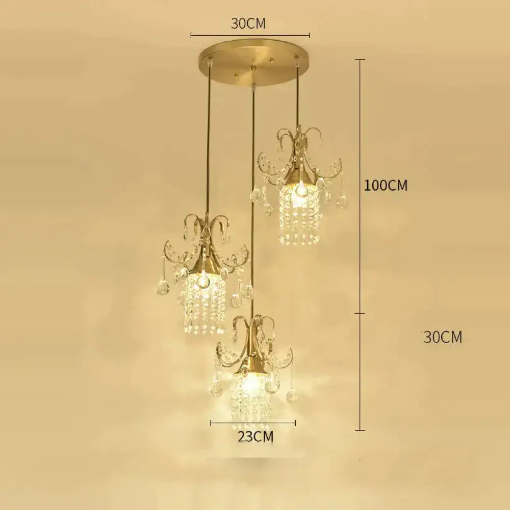 Gold-toned luxury single head pendant light with three crystal-draped lights for dining room by DecorBites