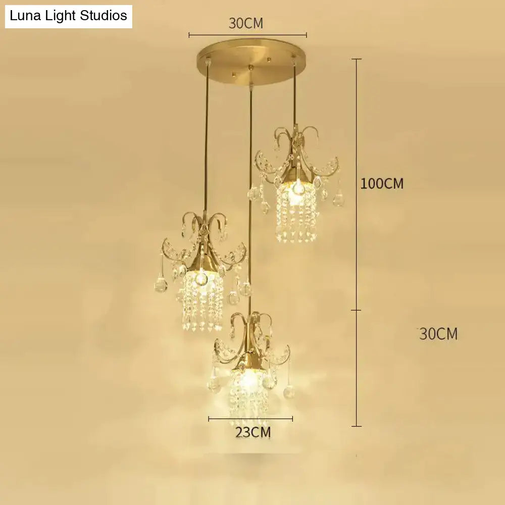 Gold-toned luxury single head pendant light with three crystal-encrusted lights for dining room by DecorBites