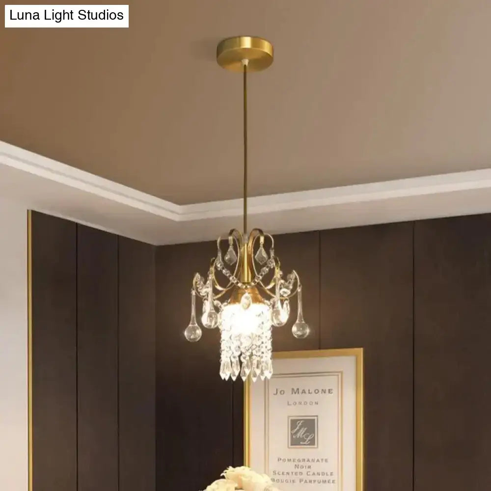 A gold-toned decorbites luxury single head pendant light with crystal teardrops and frosted glass shade for dining room