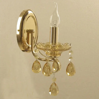 Luxury gold crystal wall sconce with amber teardrop pendants and clear candle-style bulb by decorbites crystal chandeliers