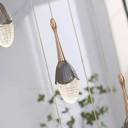 Luxury gold led staircase chandelier with a gold-toned metal stem and dark gray faceted glass shade by decorbites gold led